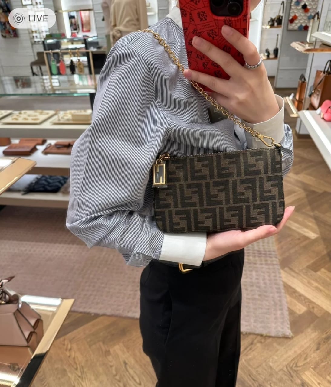 Woman carrying a Fendi style monogram shoulder bag