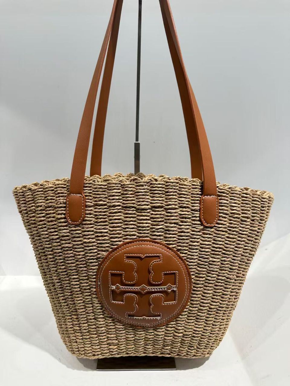 Tory Burch women's woven basket bag with brown handles and front logo