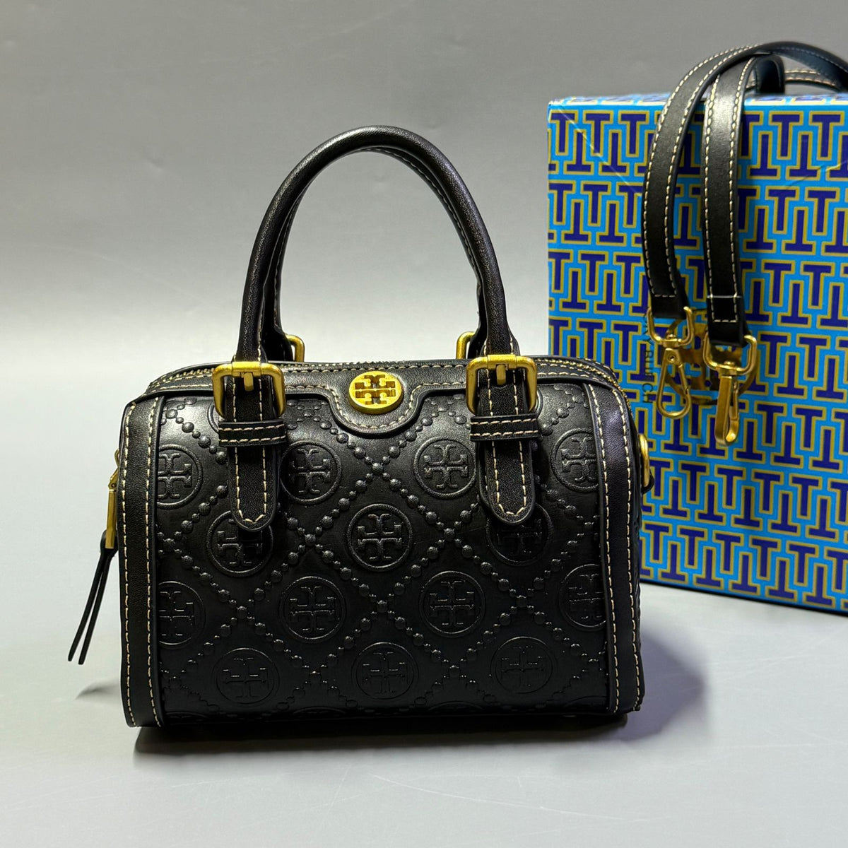 Black Tory Burch style handbag with elegant gold detailing