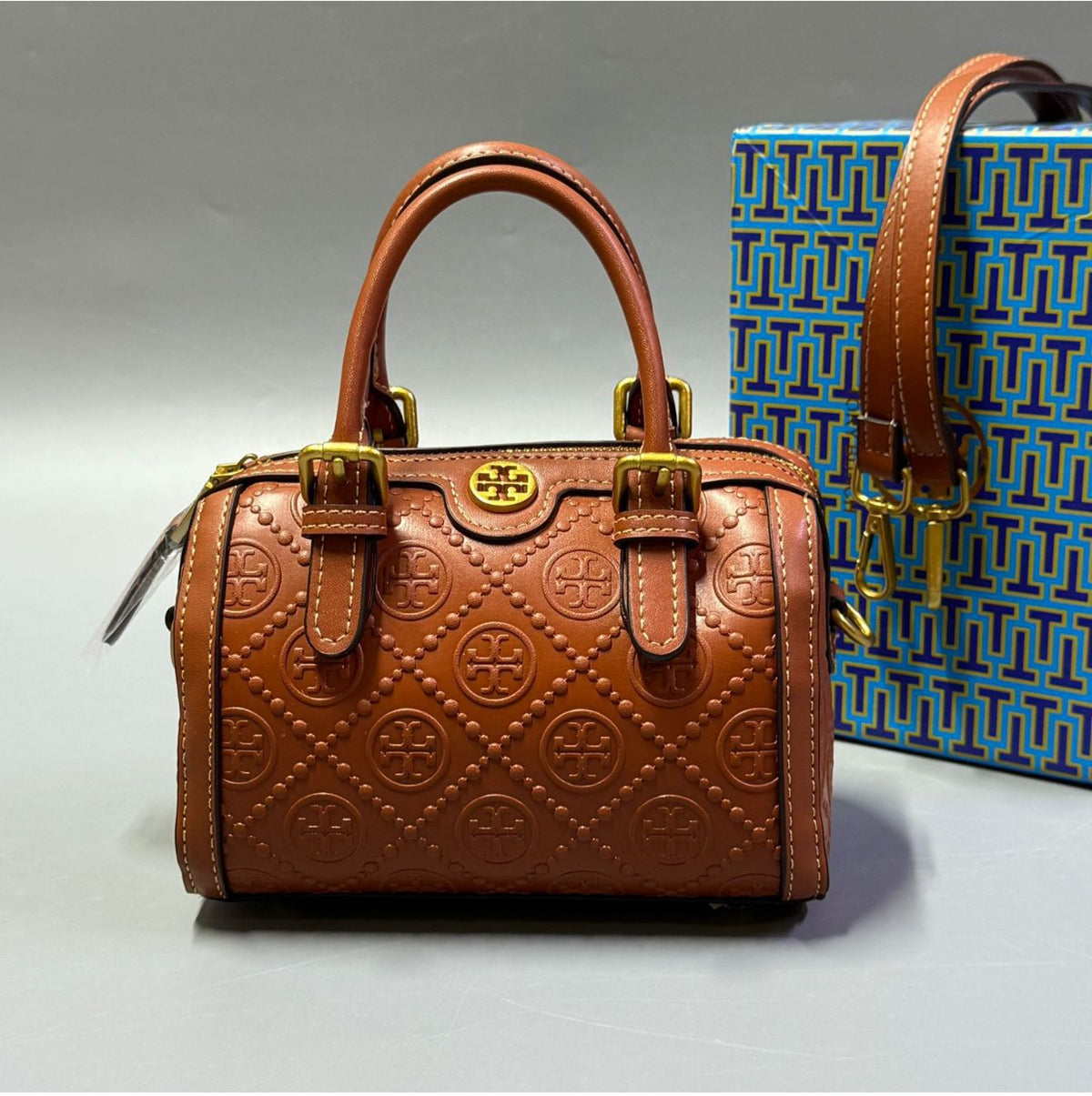 Brown Tory Burch style handbag with elegant gold detailing
