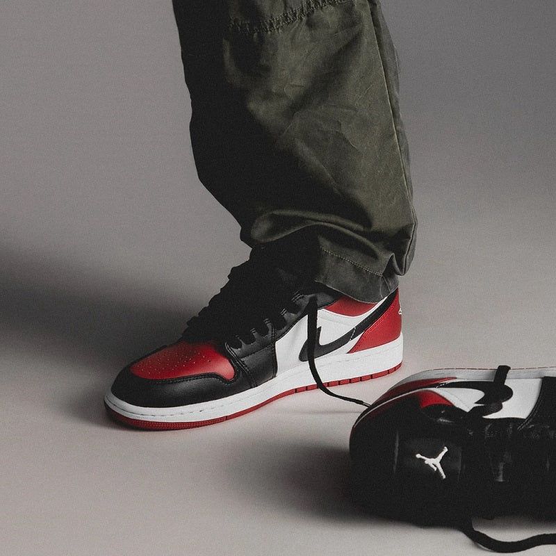 Air Jordan 1 Low Bred Toe sneakers worn on feet