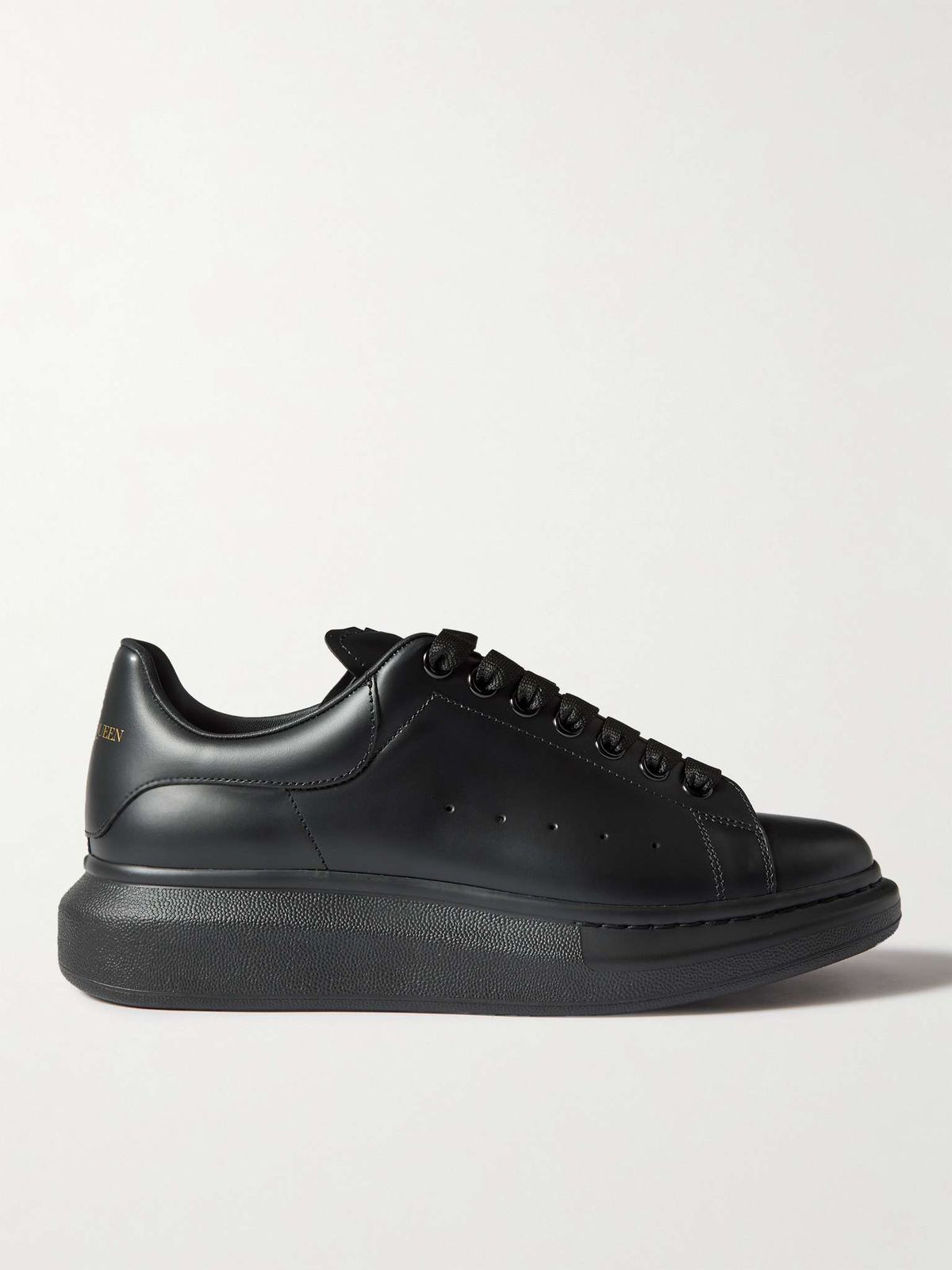 Side view of Alexander McQueen black sneaker with oversized sole