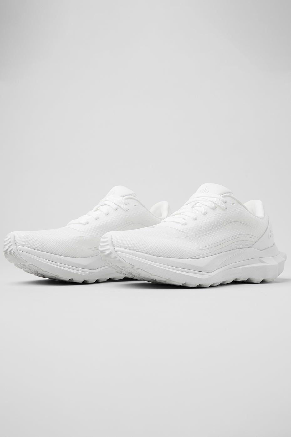 Side-angle view of white ALO Runner sneaker
