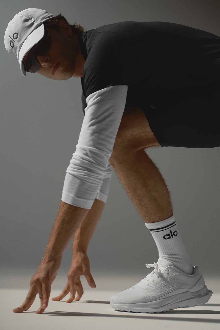 White ALO Runner sneakers styled for an athletic look