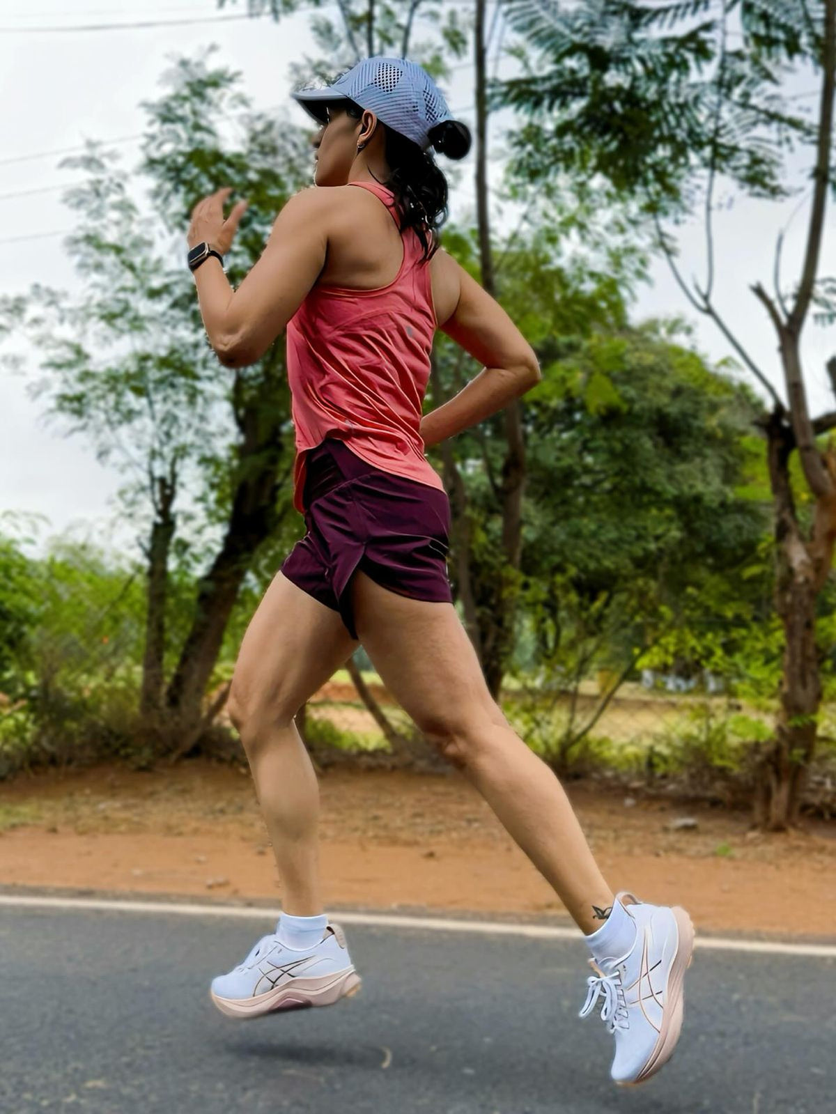 Woman running in ASICS GT-2000 13 TR Pearl Pink shoes