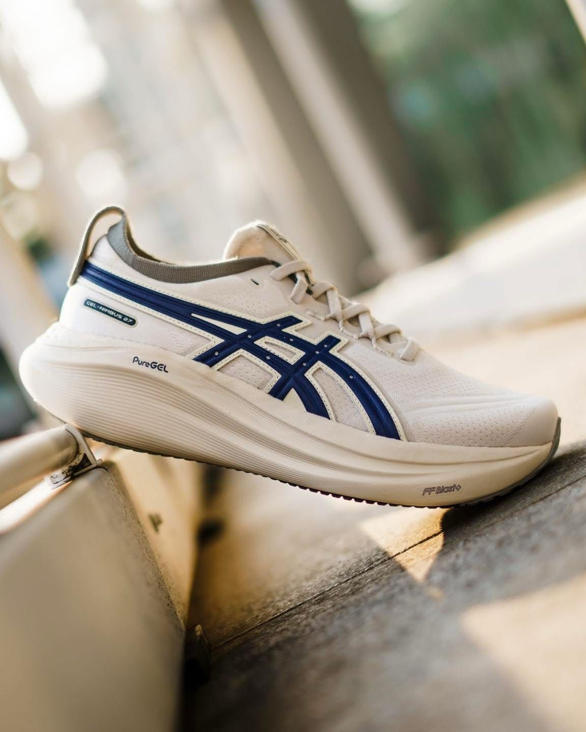Cream and blue ASICS SONICBLAST shoe in a lifestyle setting