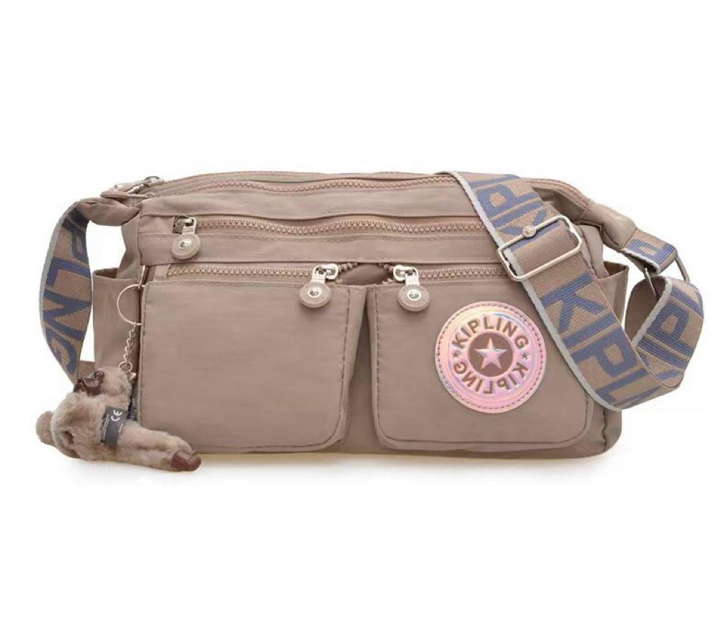 Beige Kipling style shoulder bag with adjustable strap