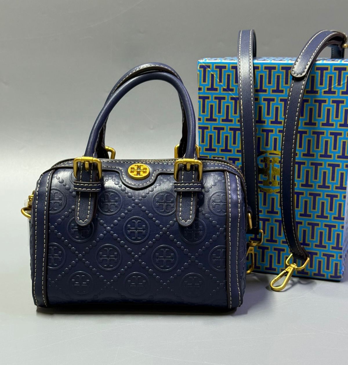 Blue Tory Burch style handbag with elegant gold detailing