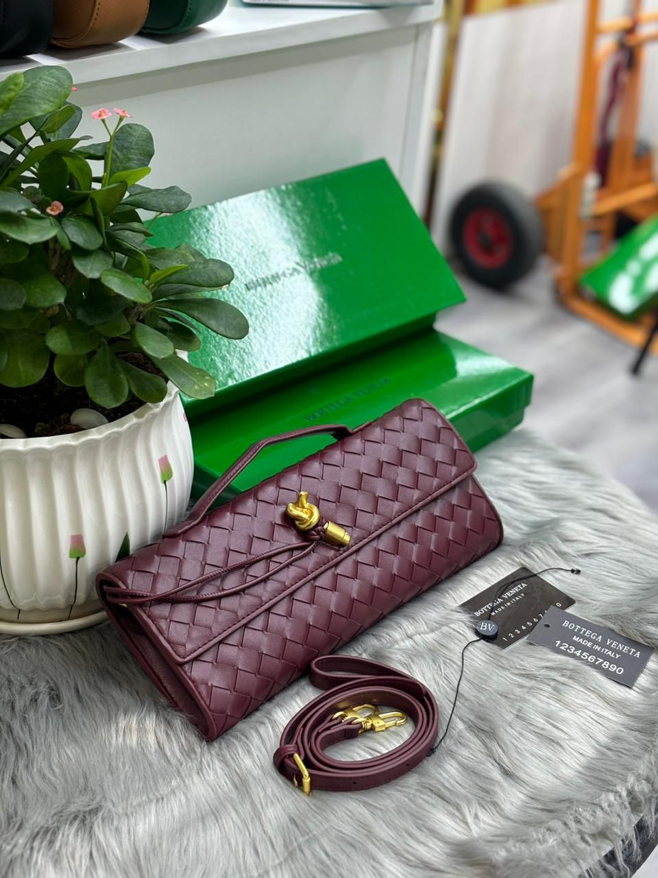 Burgundy red Bottega Veneta woven leather knot clutch bag