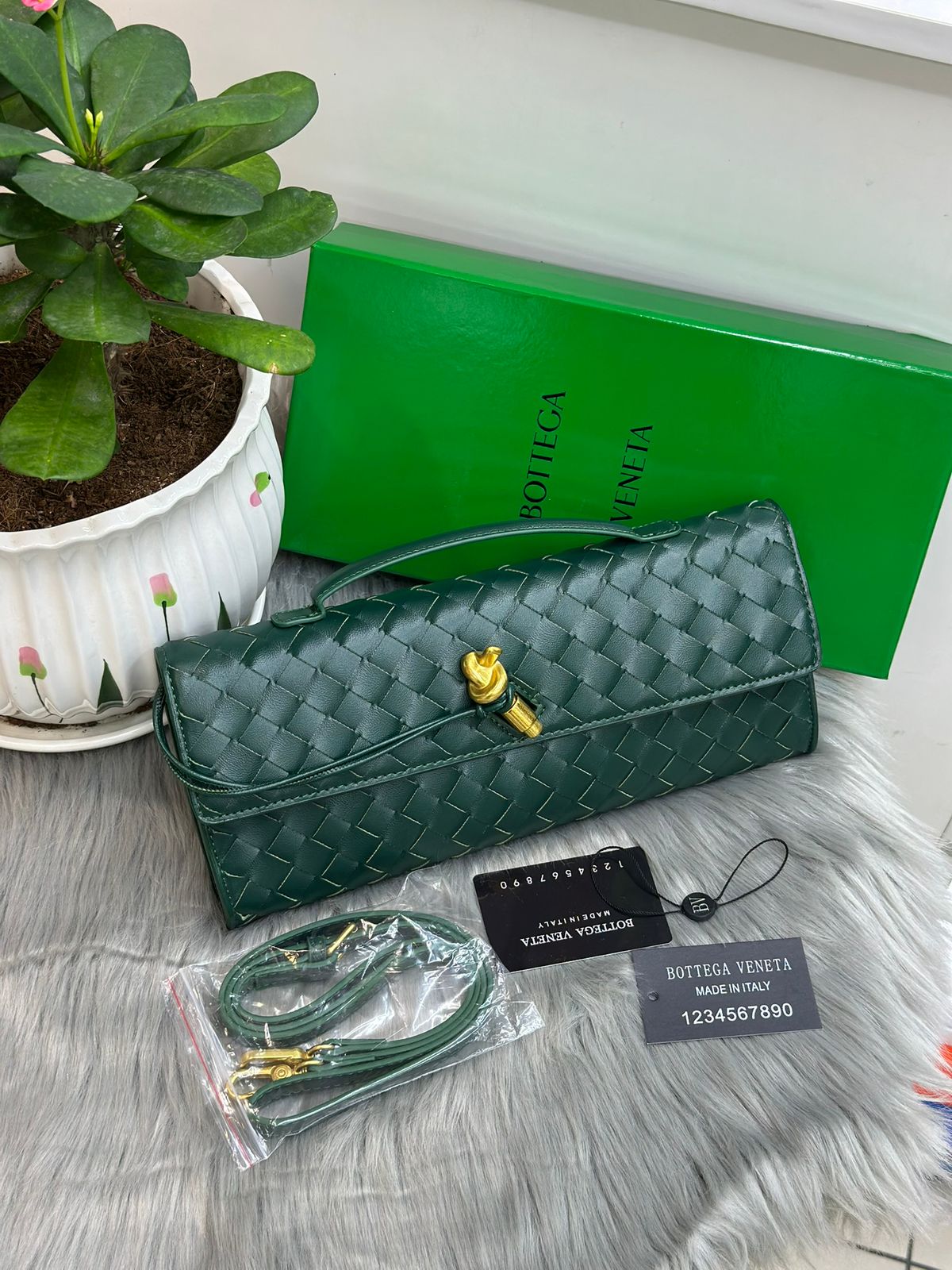 Emerald green Bottega Veneta woven leather knot clutch bag with green box