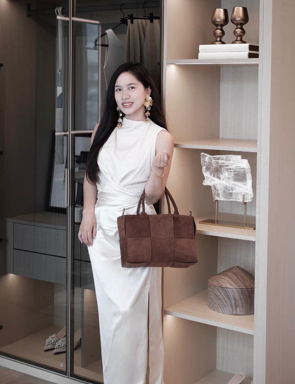 Woman carrying Bottega style brown woven women's handbag