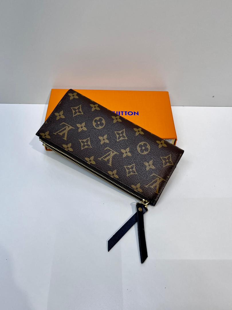 Front view of brown monogram wallet with black strap