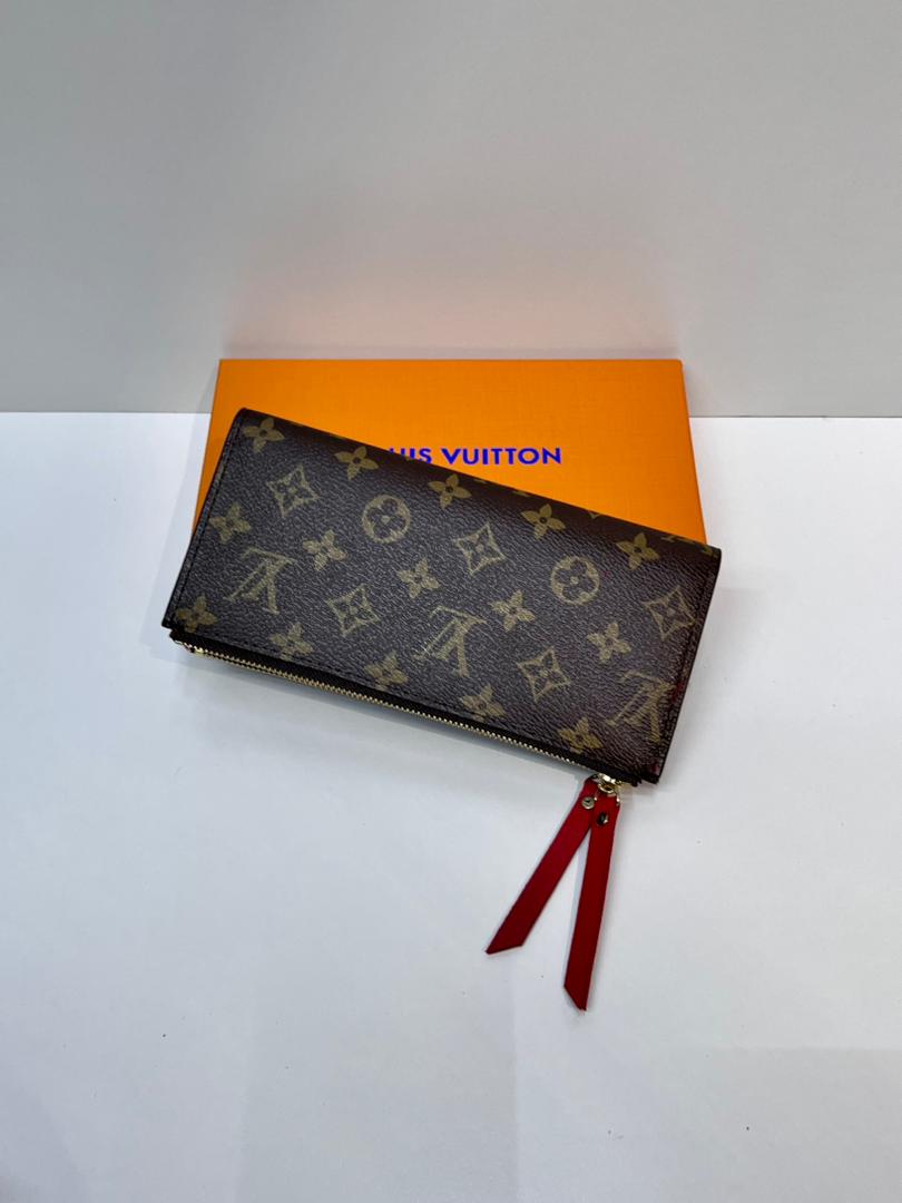 Brown monogram women’s wallet with red wristlet strap