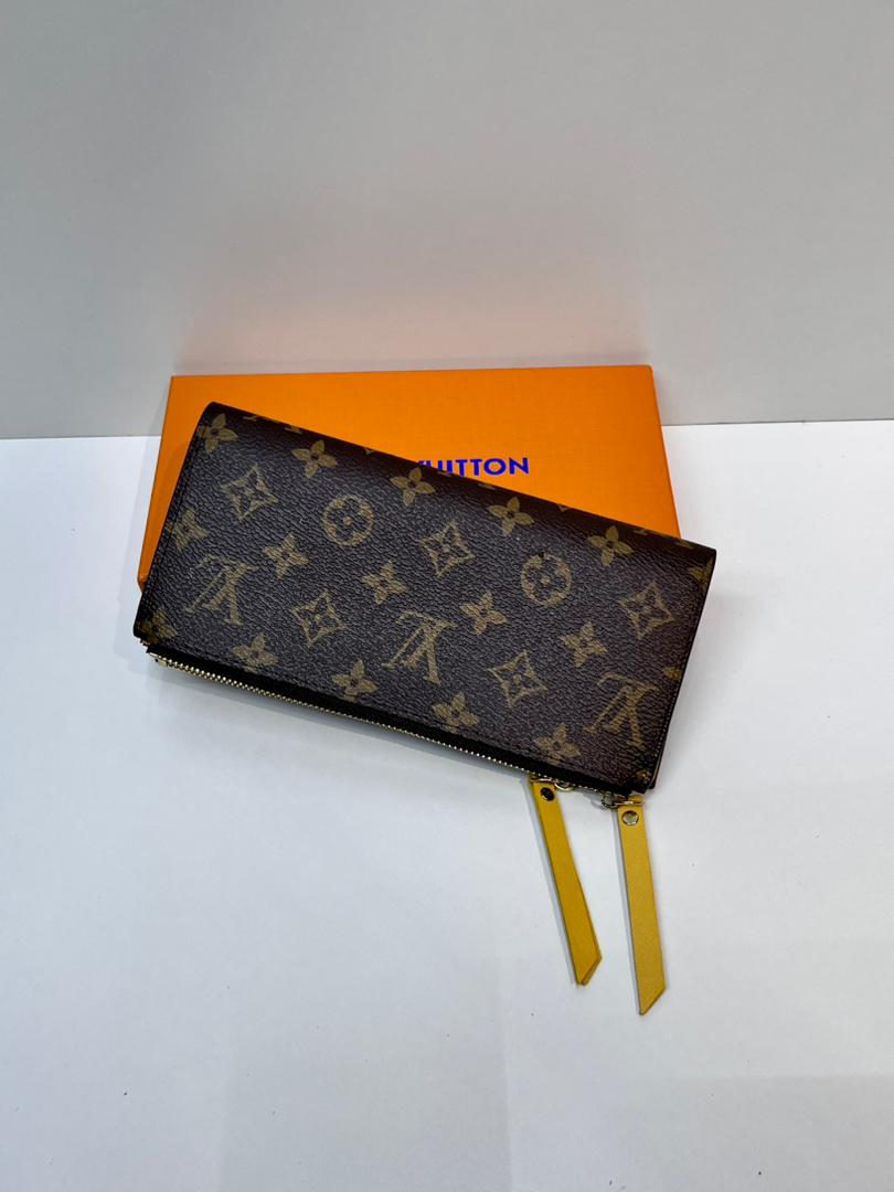 Brown monogram compact wallet with yellow wrist strap
