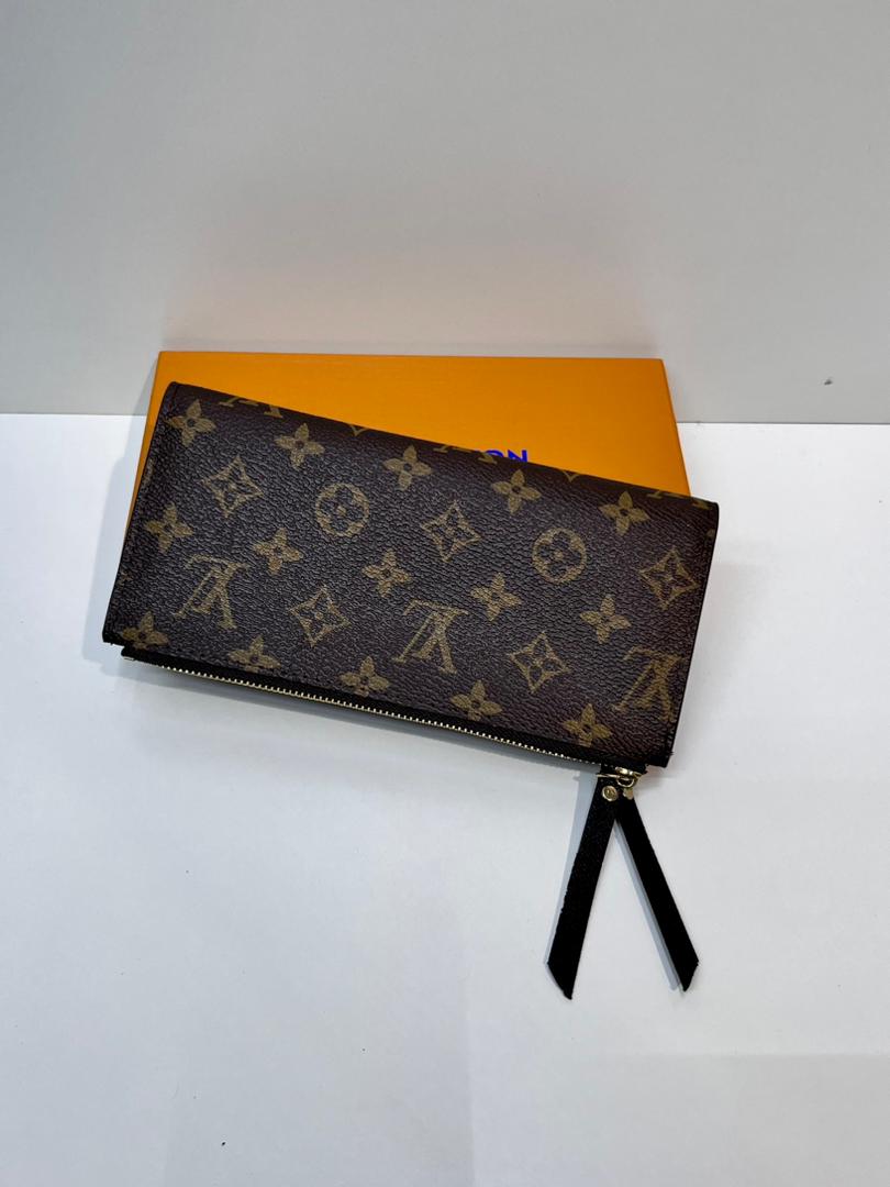 Brown monogram women’s zip wallet with black wrist strap