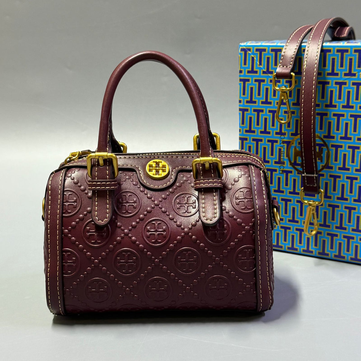 Brown Tory Burch style handbag with elegant gold detailing