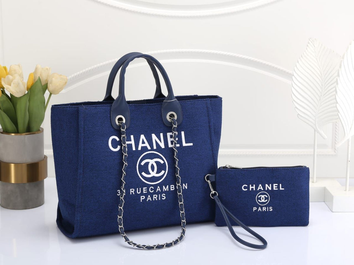 Chanel blue handbag with matching pouch on a white background
