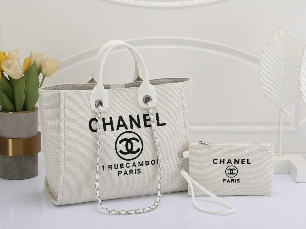 Chanel handbag and pouch on a white surface with a minimal background