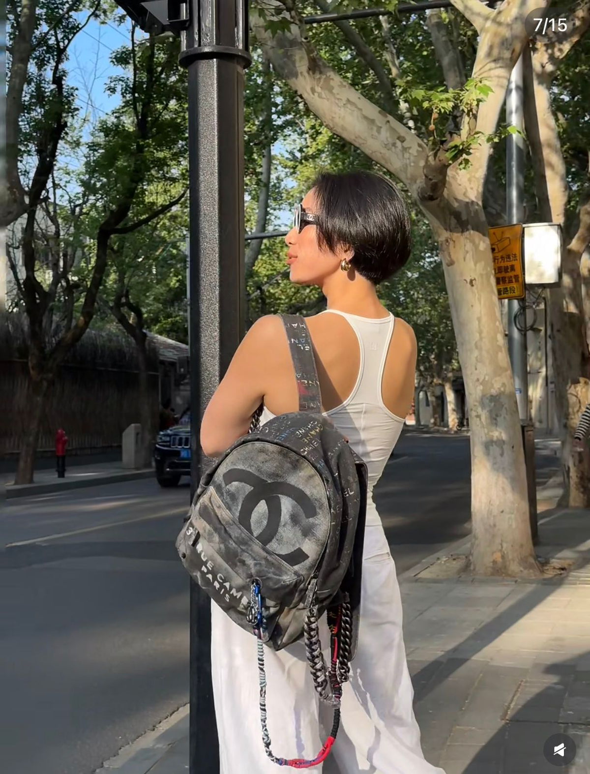 Person wearing a Chanel backpack on a city street