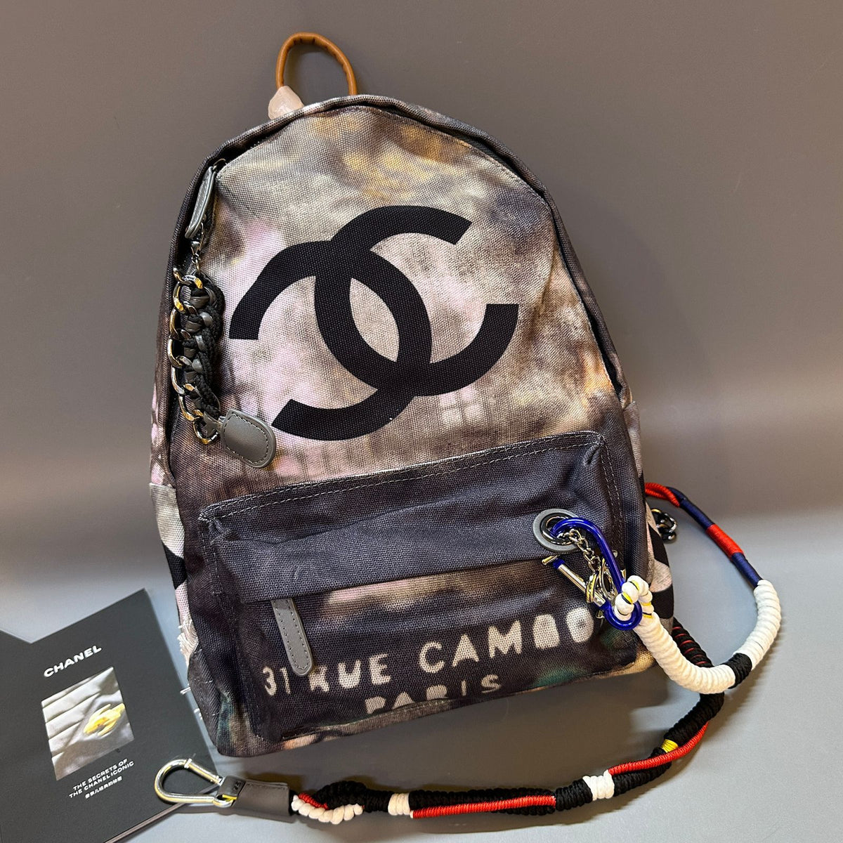 Backpack with Chanel logo and '31 Rue Cambon' text on a gray background