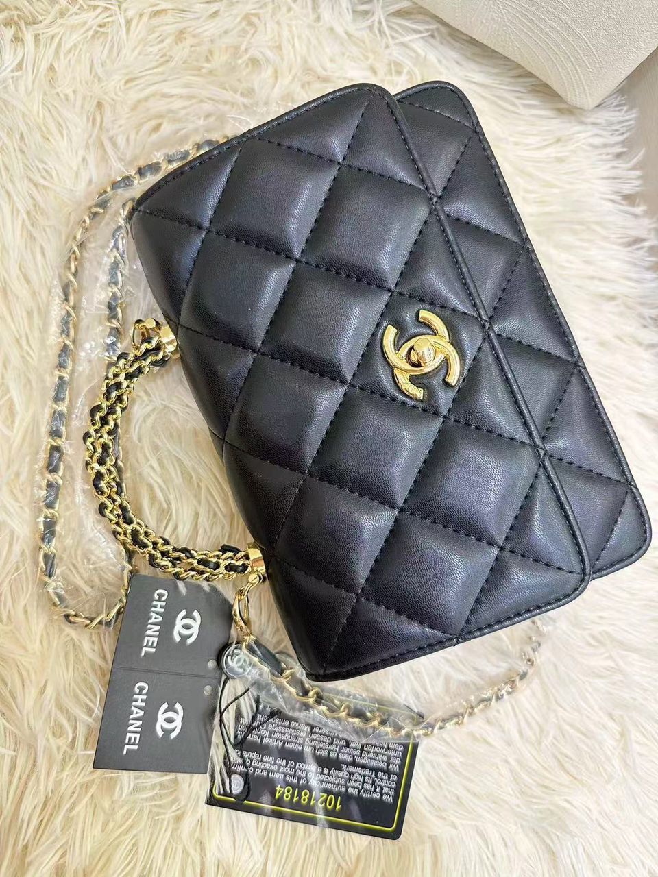 Classic black Chanel quilted leather mini flap bag with gold CC turn-lock