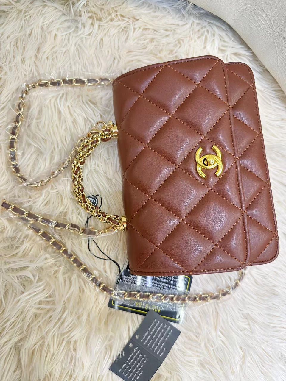 Chanel quilted leather mini flap bag in chestnut brown with gold CC turn-lock by Aone Brands Dubai