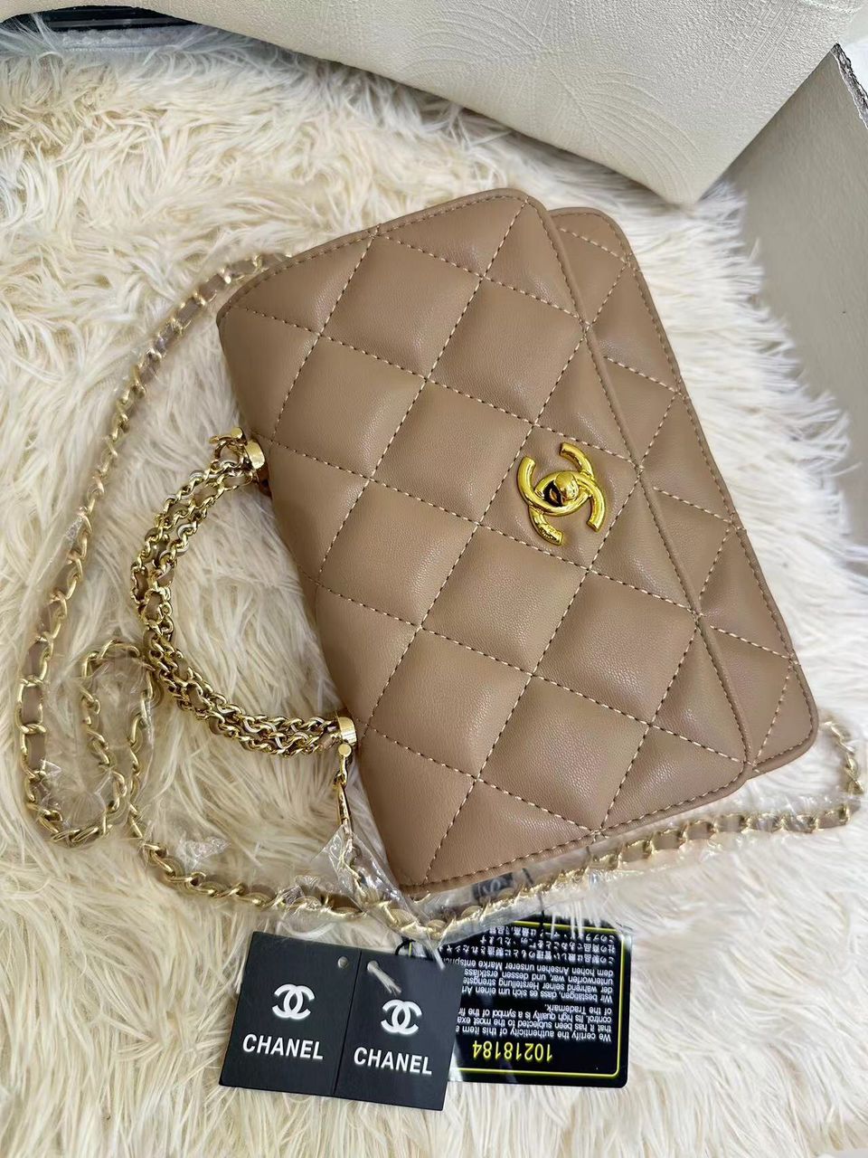 Warm taupe beige Chanel quilted mini flap handbag with gold-tone hardware