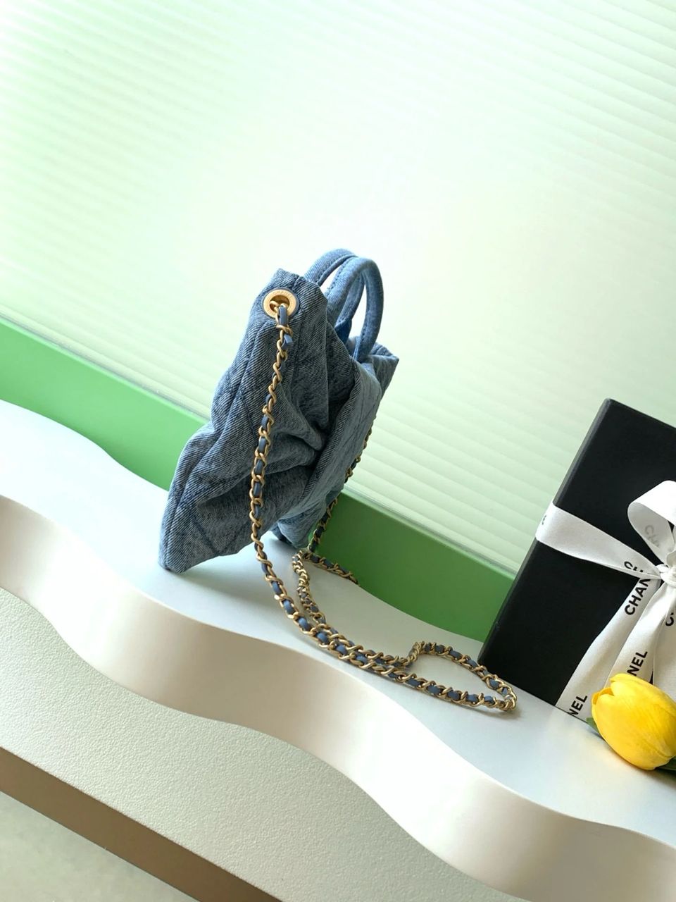 Side view of Chanel women’s quilted mini bag