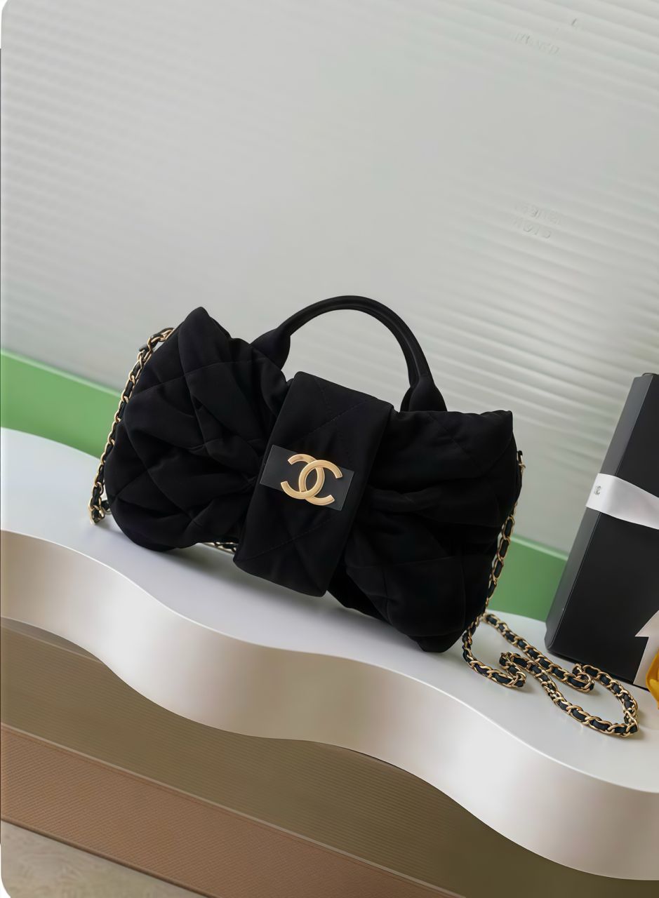 Front view of black Chanel women’s mini bag