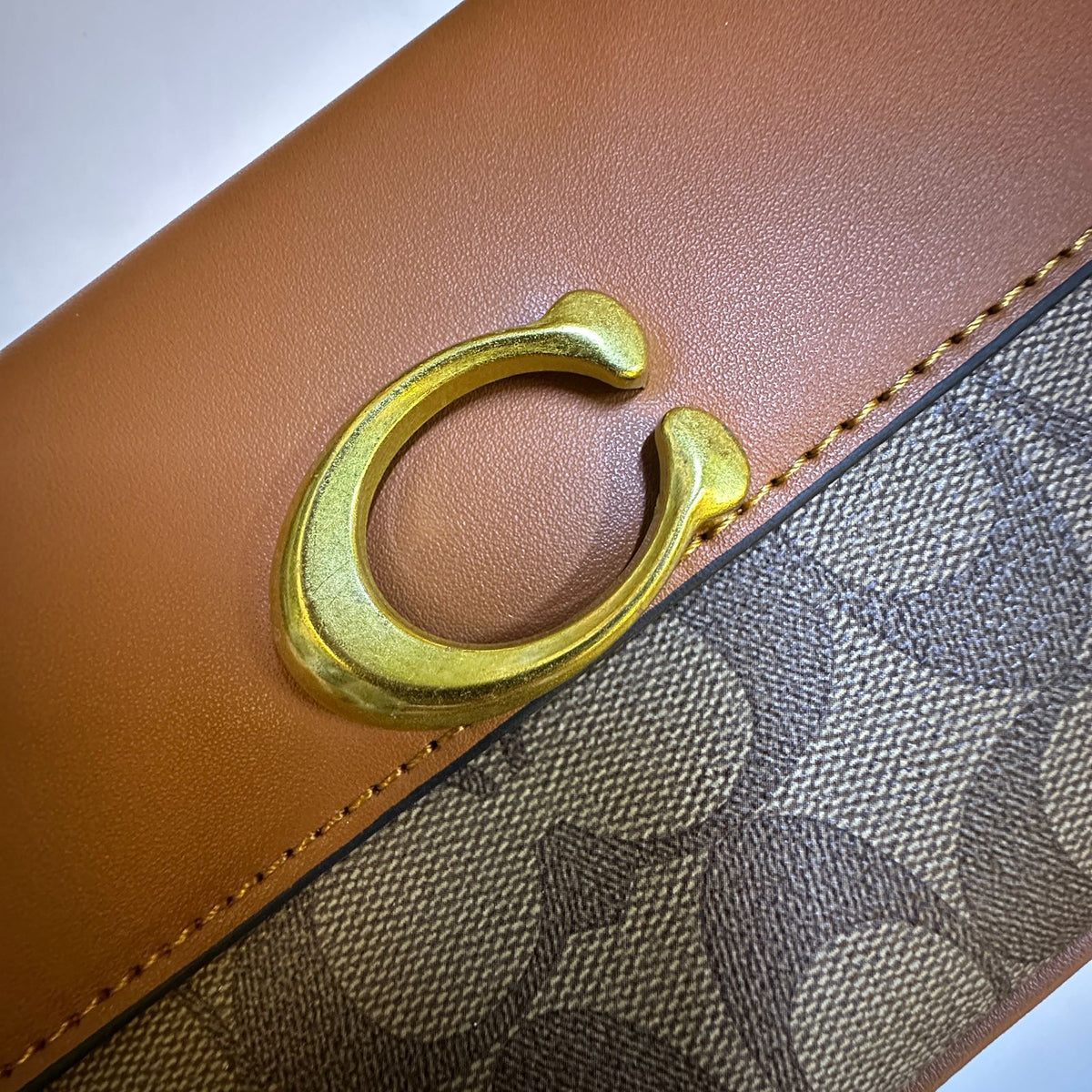 Elegant metal detailing on Coach style women's handbag