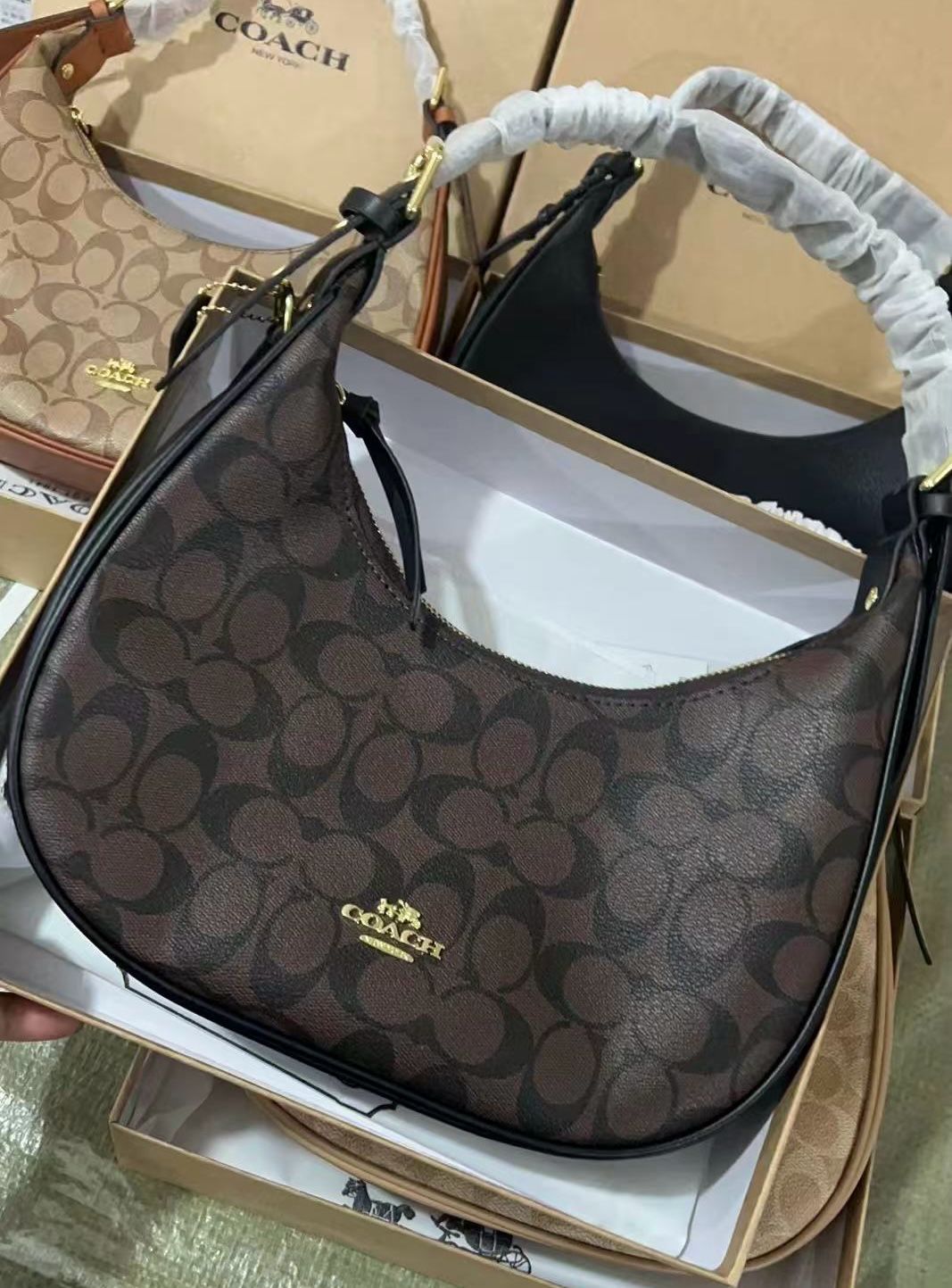 Coach handbag with brand logo in a box