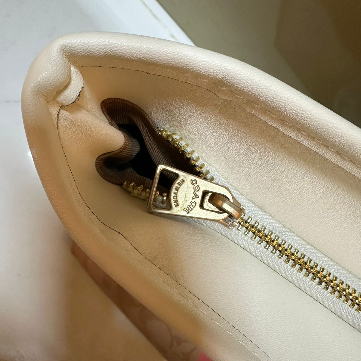 Open main interior compartment view of Coach signature leather shoulder tote bag