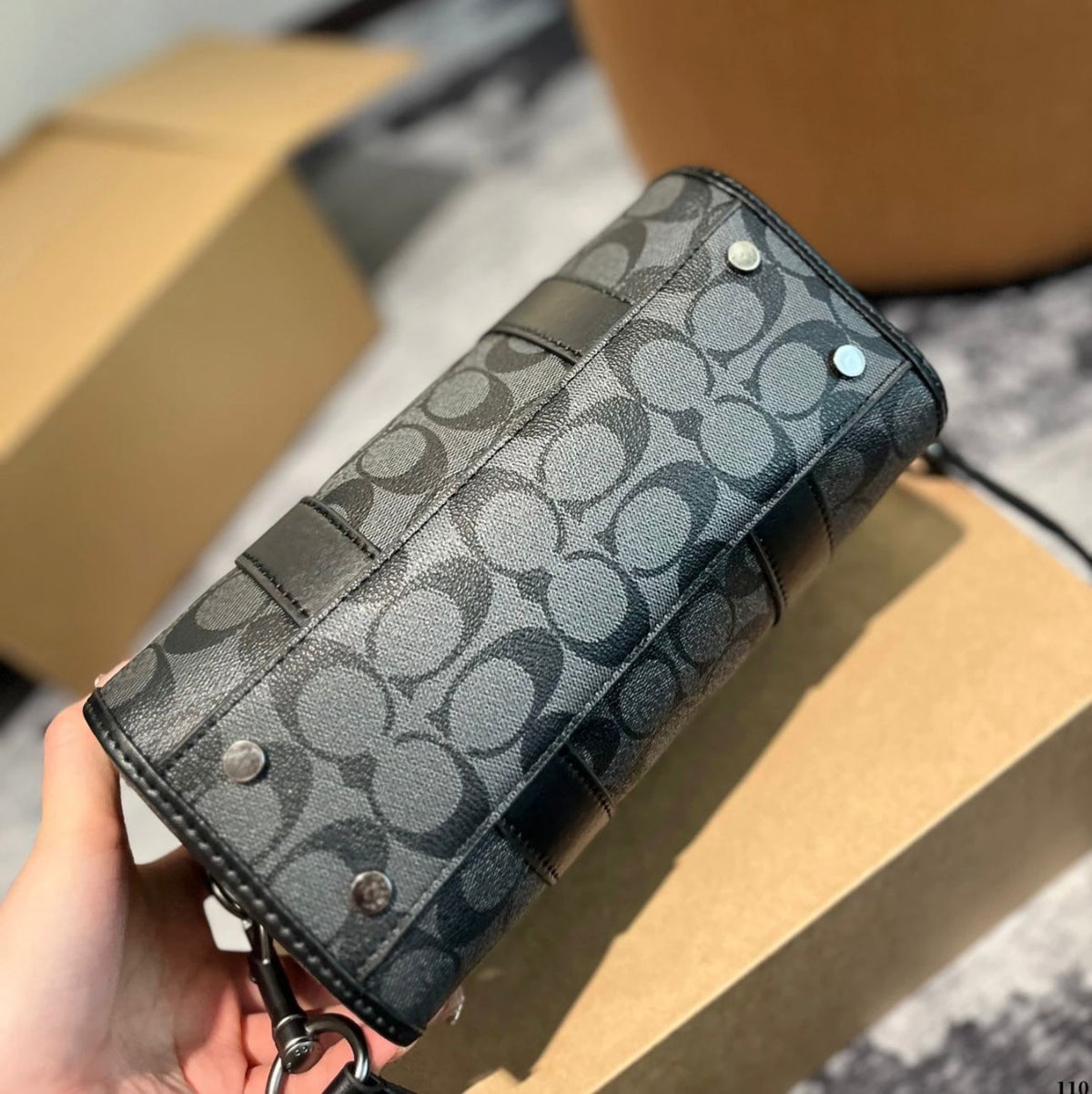 Side view of black Coach style handbag for women