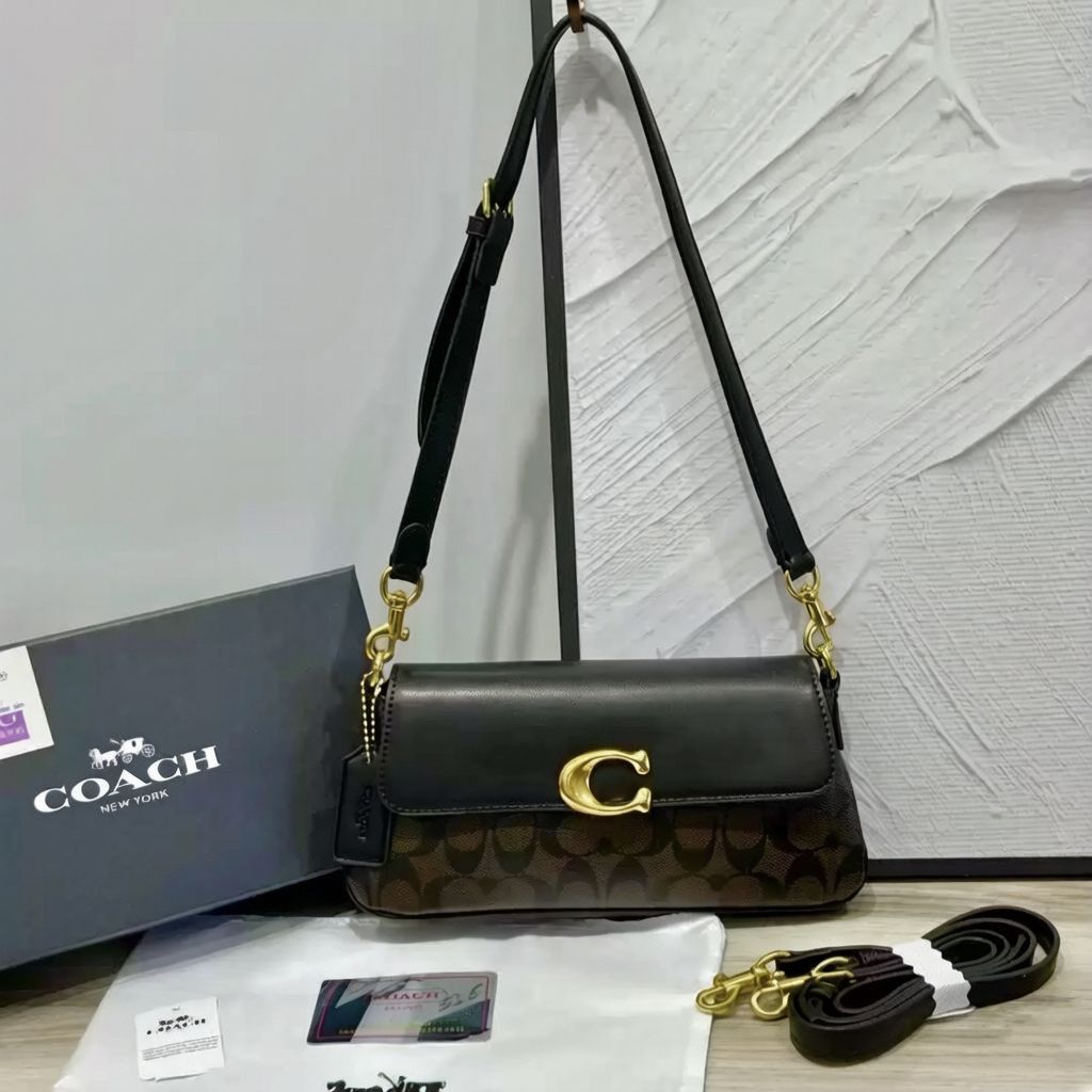 Black Coach women's shoulder bag displayed with elegant chain strap design
