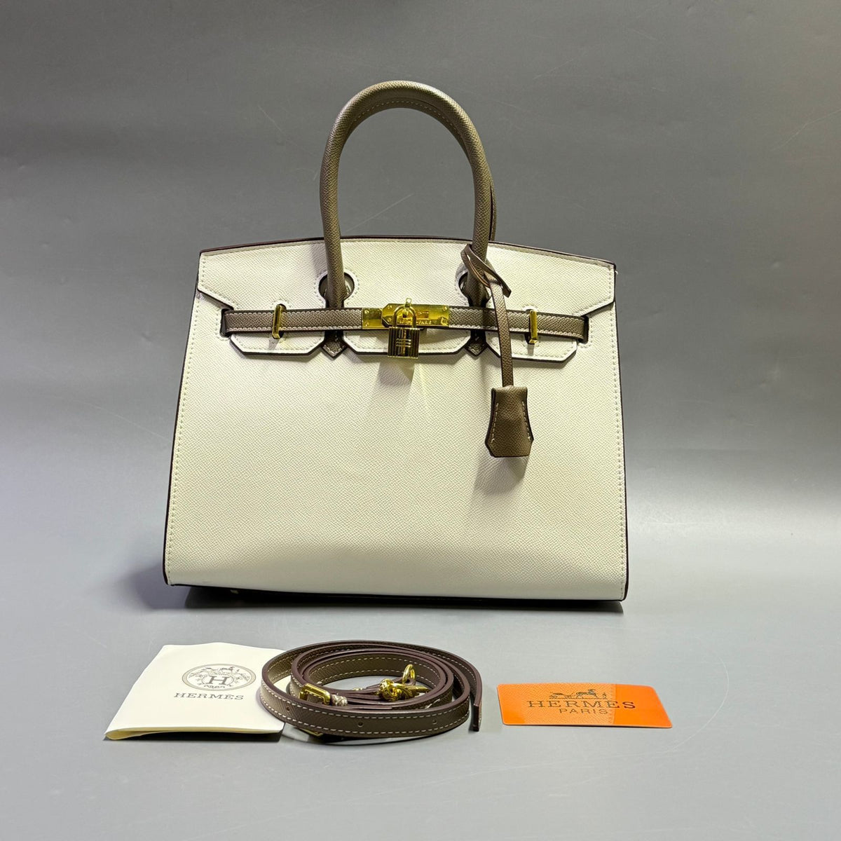 Cream white luxury leather handbag with contrasting dark top handles