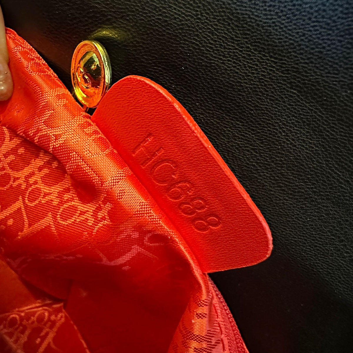 Gold hardware detailing on Dior style women's handbag