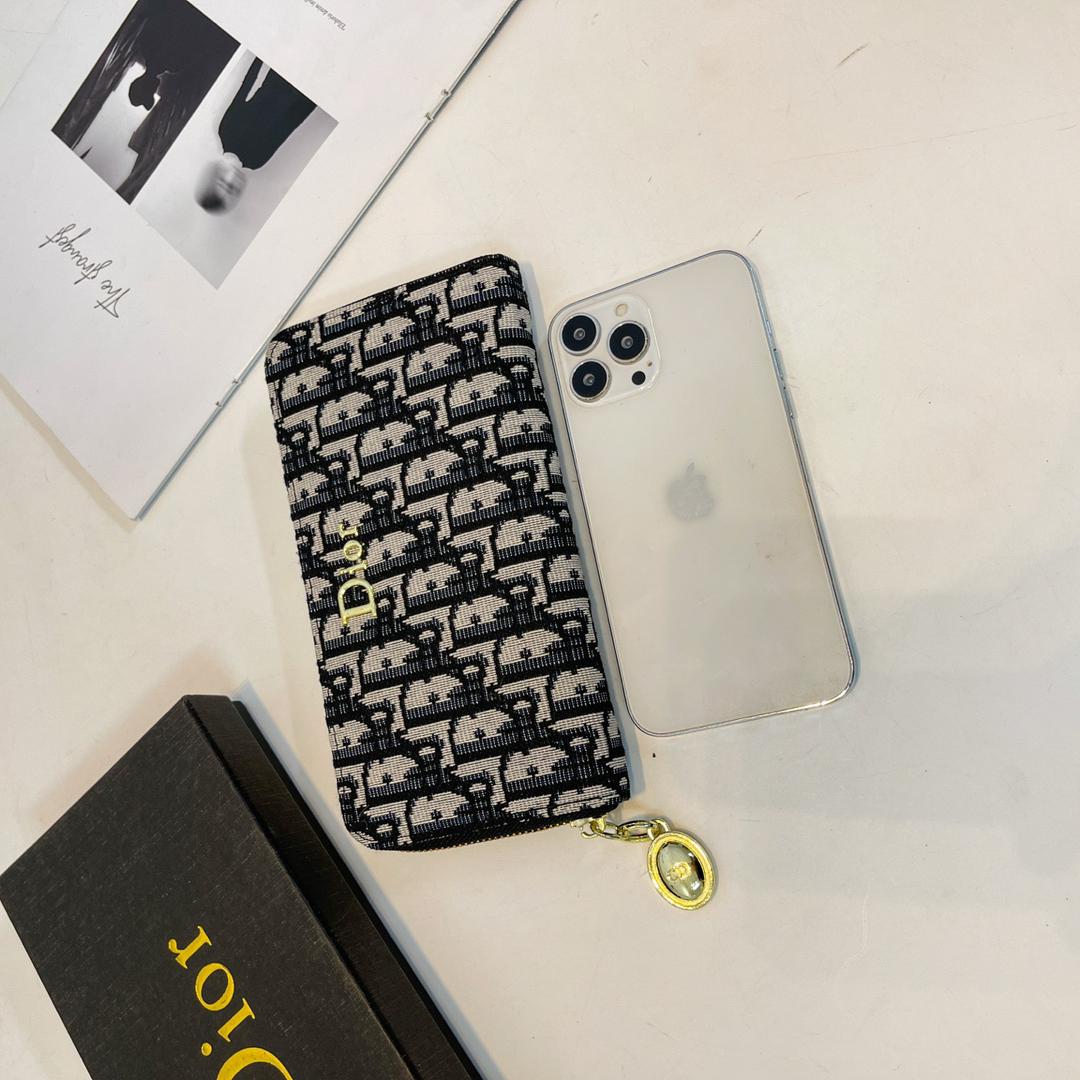 Dior patterned women’s wallet displayed beside a phone