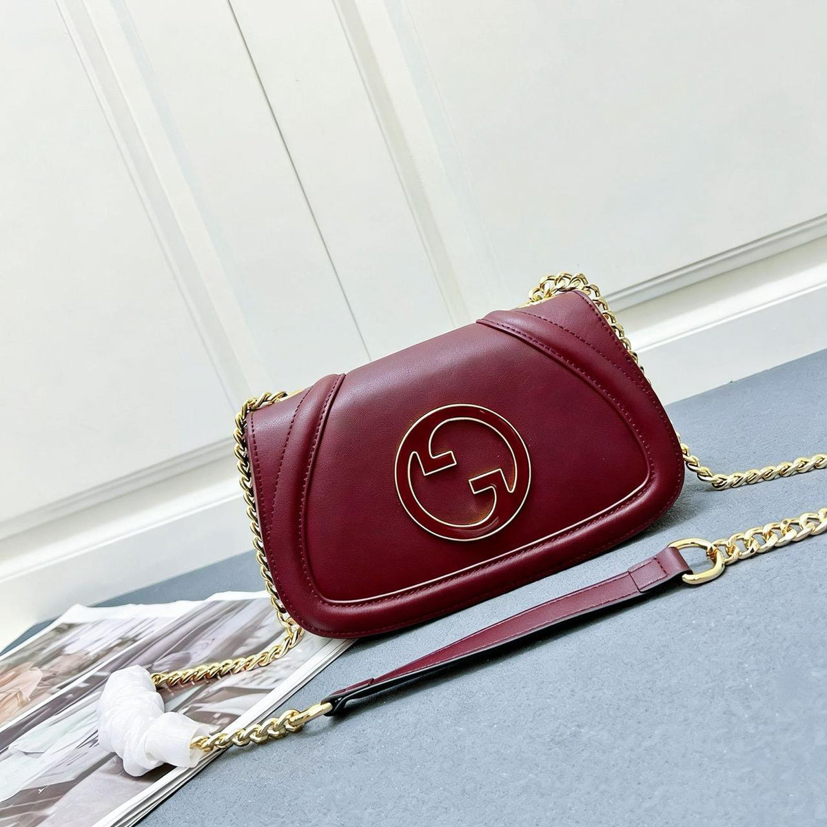 Burgundy red Gucci leather crossbody bag with gold chain strap