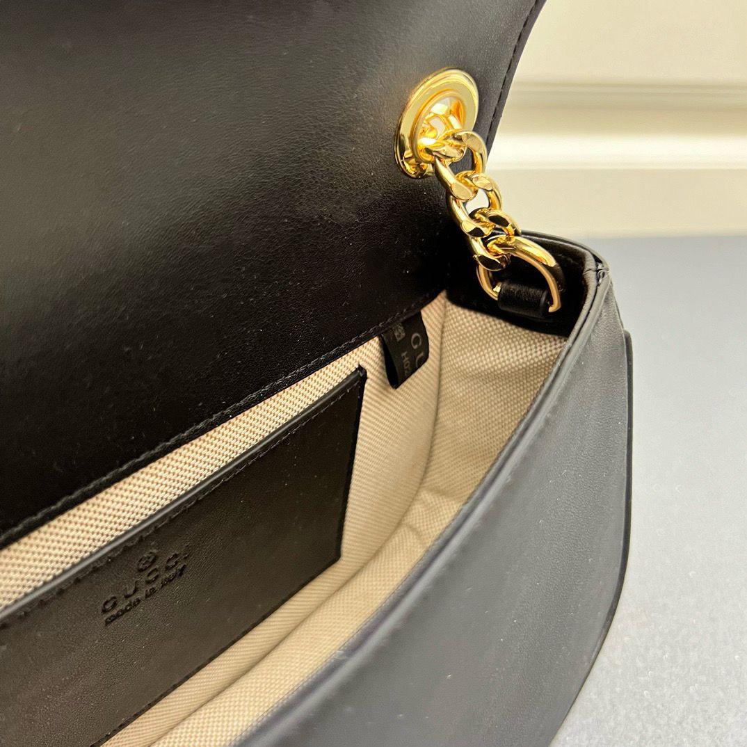 Inside view of open Gucci leather crossbody bag showing interior pocket