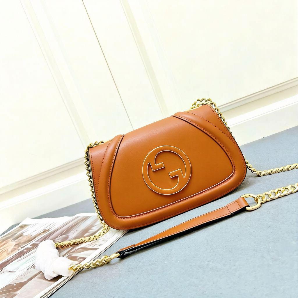 Tan brown Gucci leather crossbody shoulder bag with round gold logo