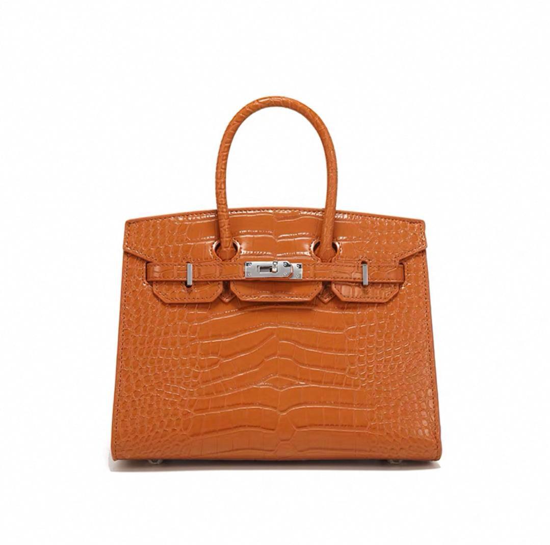 Orange Hermès women’s satchel bag with front closure
