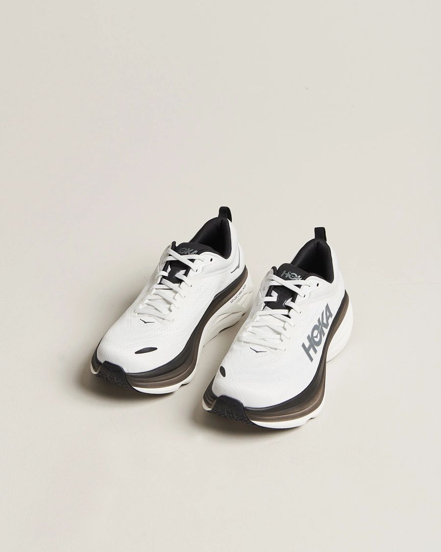 Pair of HOKA Bondi 9 White Black running shoes
