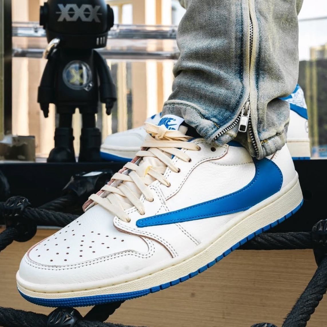 Jordan 1 Low white and blue sneakers on feet
