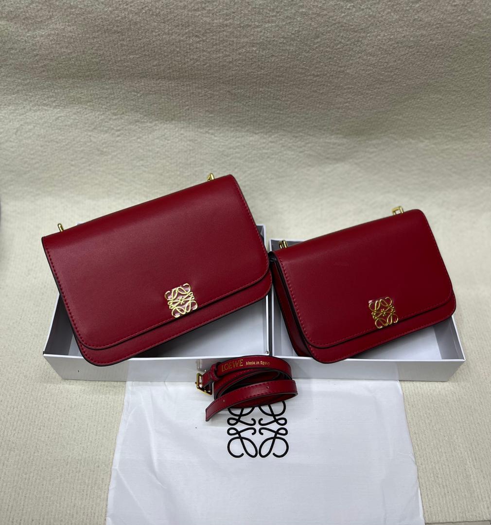 Red Loewe handbags with flap design and shoulder straps