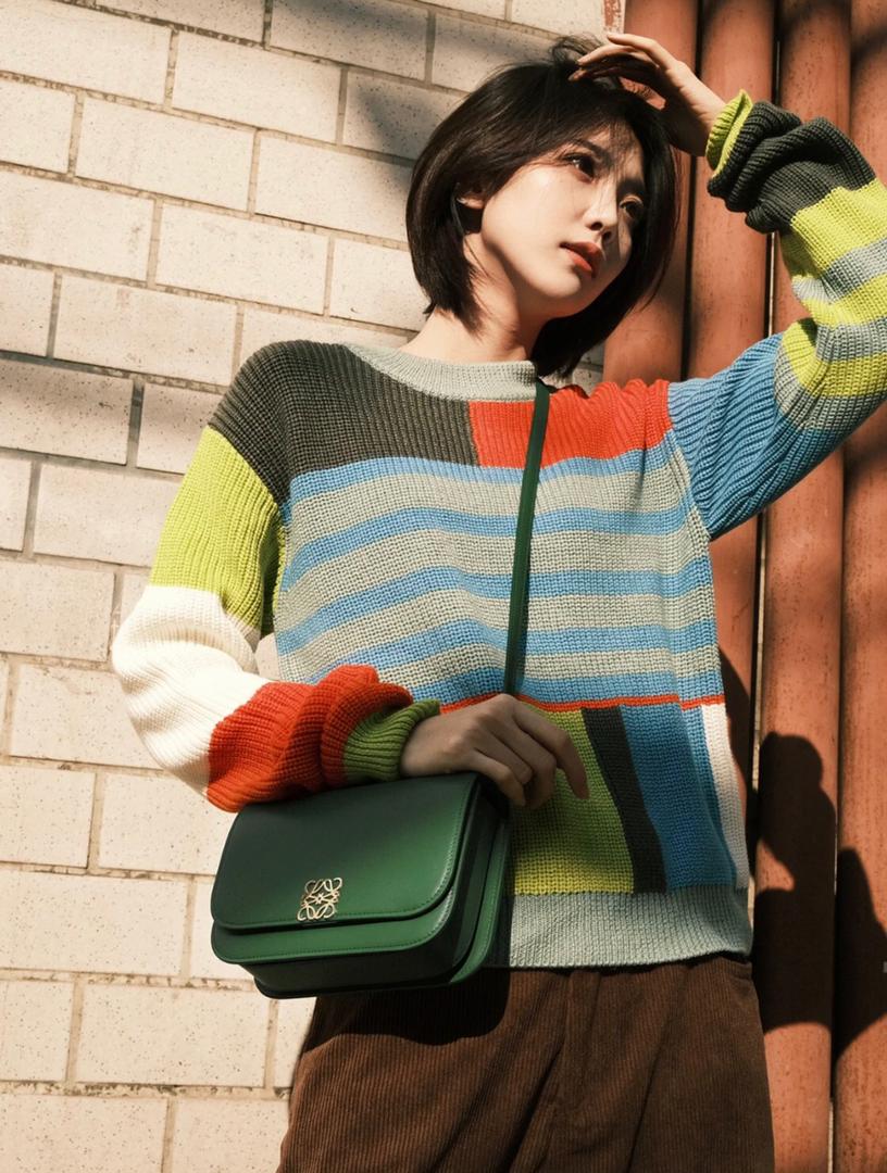 Woman carrying a Loewe style handbag with casual outfit