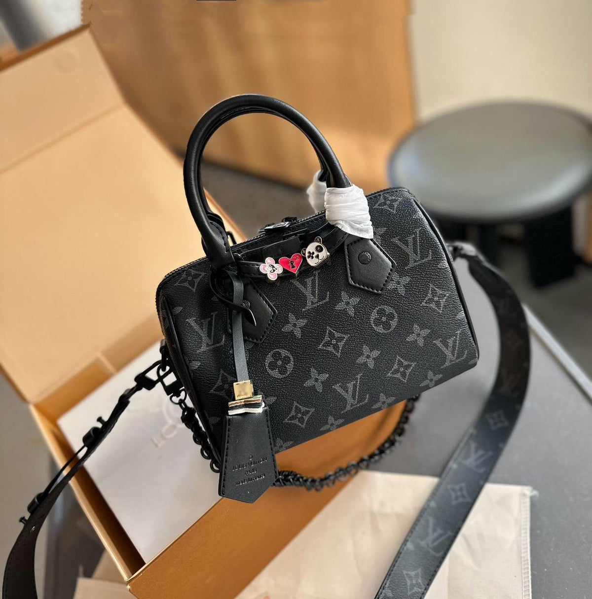 Black monogram canvas Louis Vuitton mini top handle bag with charms