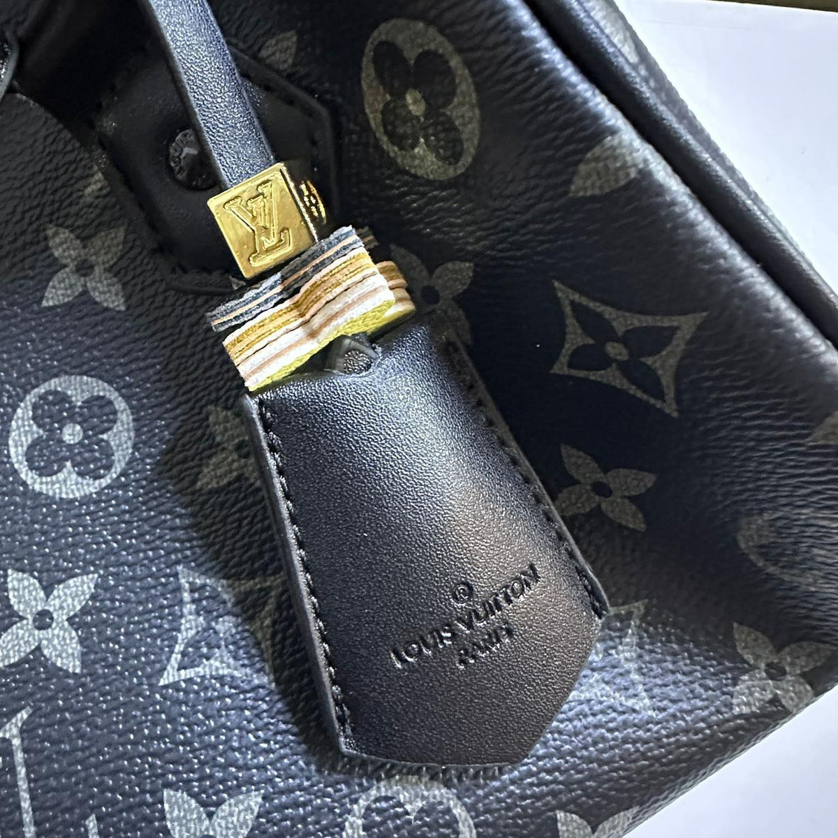 Close up of leather clochette key bell attachment on Louis Vuitton bag