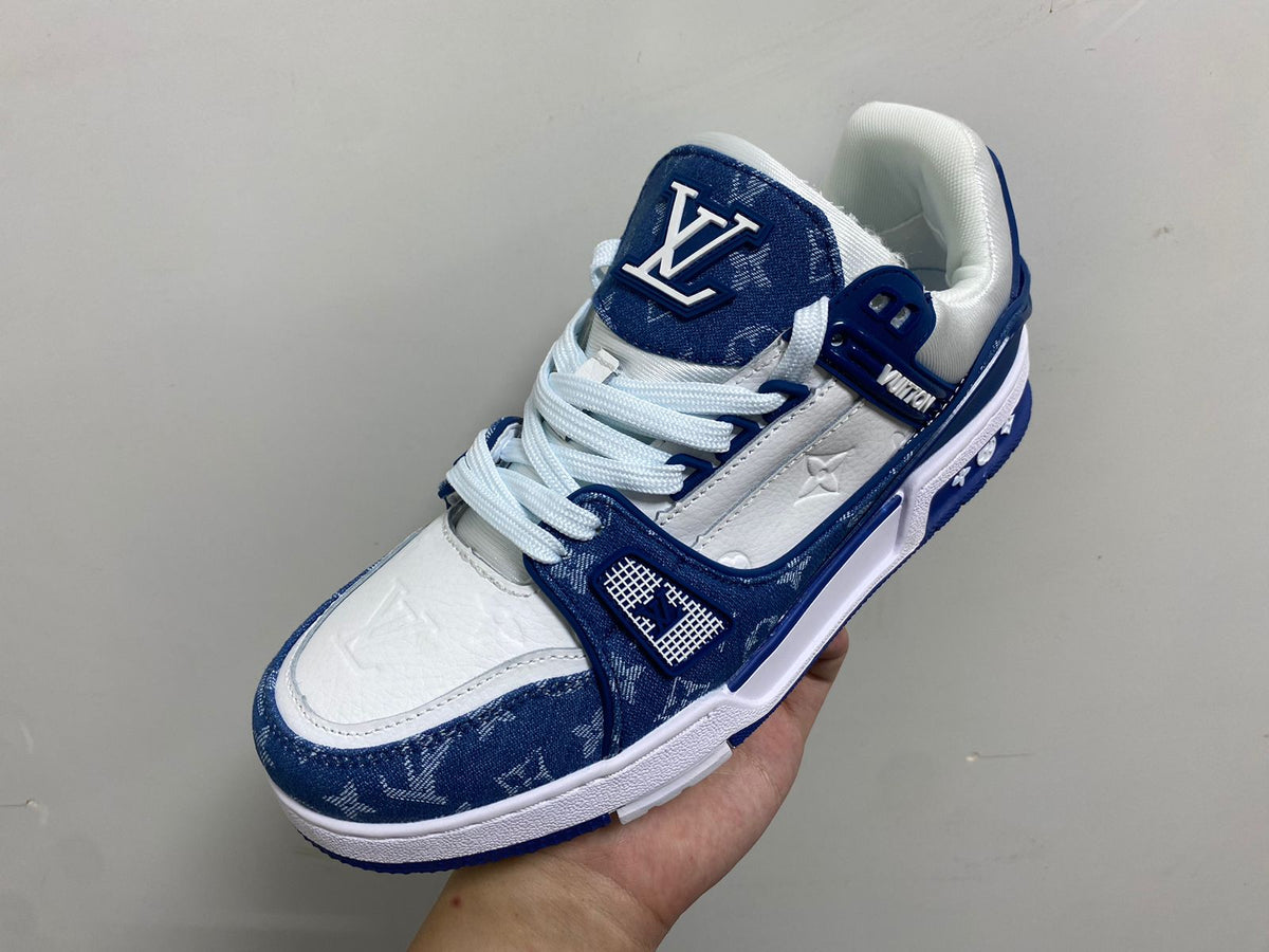 Louis Vuitton LV Trainer Blue Monogram denim shoe held in hand