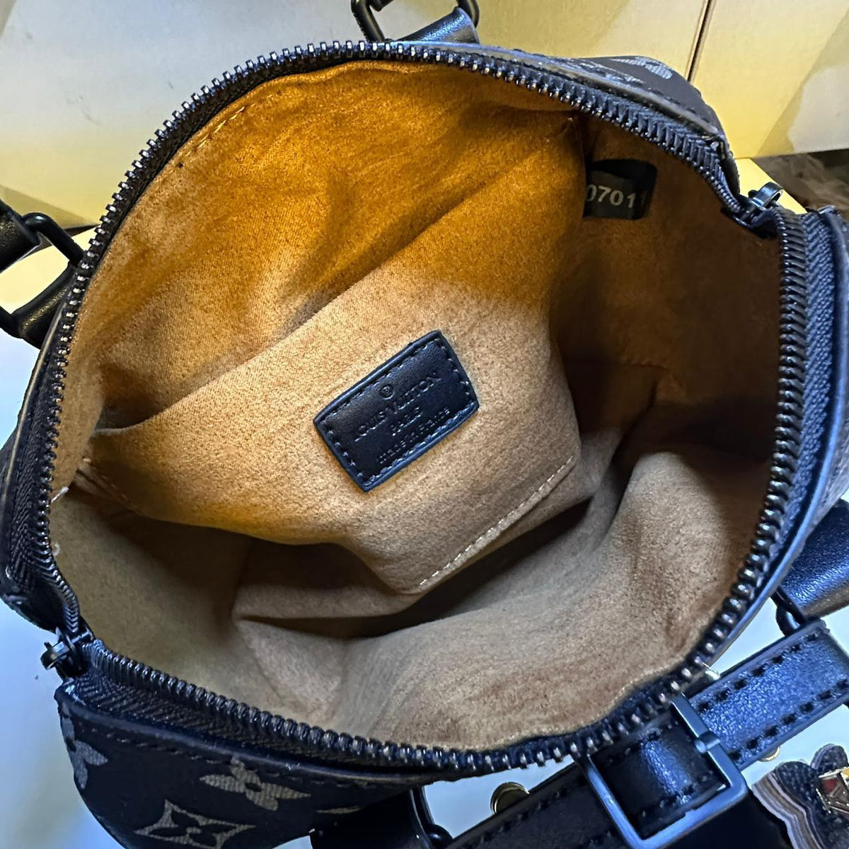 Interior soft lining compartment view of Louis Vuitton mini top handle bag
