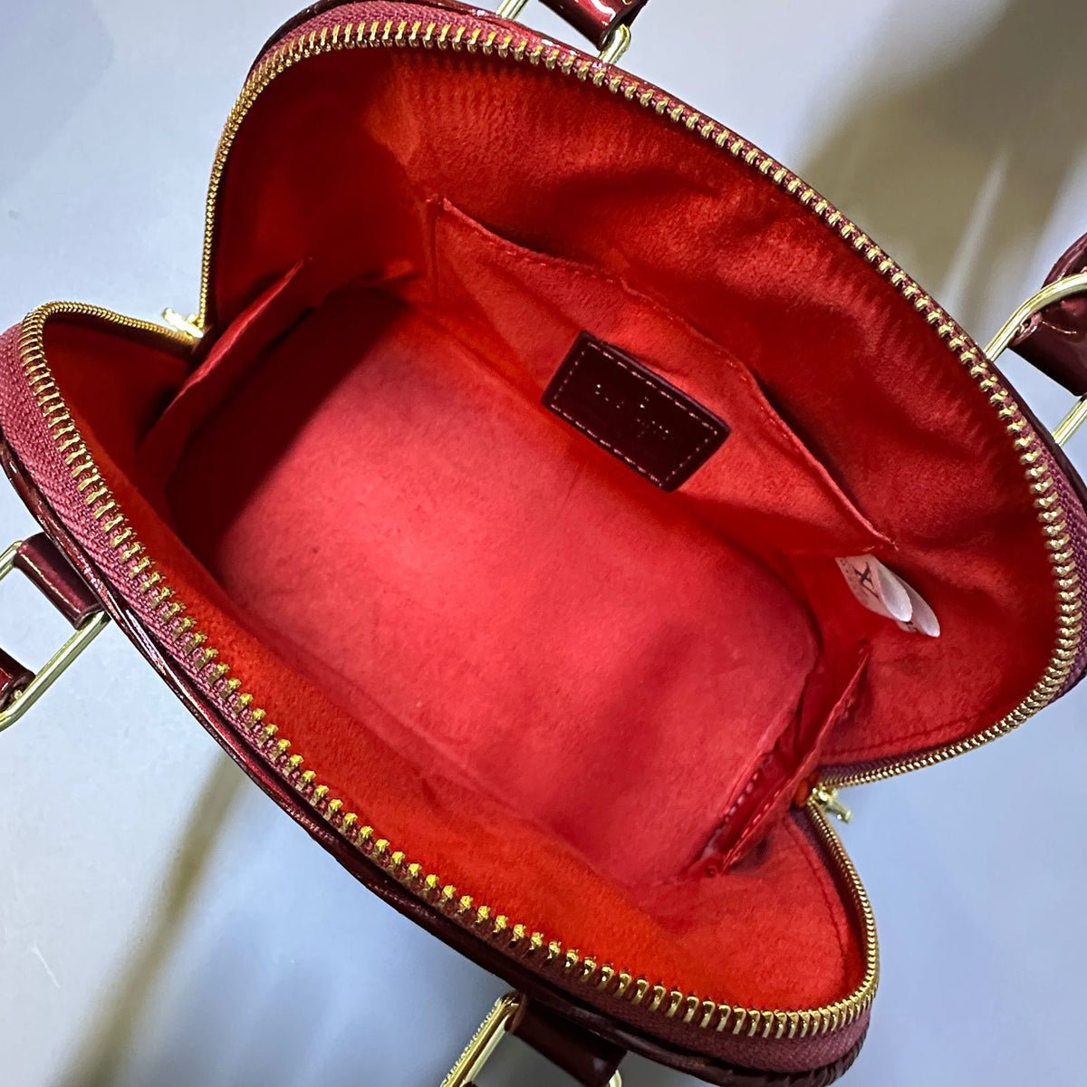 Women's top handle bag interior with spacious storage design